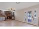 Bright living room featuring fireplace, ceiling fan, and glass panel french doors with outdoor views at 429 Sunburst Dr, Henderson, NV 89002