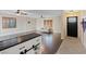 Open-concept living area featuring hardwood floors, windows, and an adjacent kitchen at 429 Sunburst Dr, Henderson, NV 89002