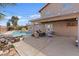 A covered patio with an in-ground pool surrounded by mature trees at 429 Sunburst Dr, Henderson, NV 89002