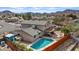 Beautiful property featuring a sparkling pool, covered patio, and lush landscaping in the backyard at 429 Sunburst Dr, Henderson, NV 89002