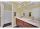 Bright bathroom featuring double sinks, wood vanity, and shower-tub combination at 4322 Summers Shade St, Las Vegas, NV 89147