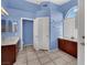 Bathroom featuring tile flooring, blue walls, and a built-in vanity space at 4322 Summers Shade St, Las Vegas, NV 89147