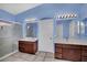 Bathroom with dual vanities, tile floor, blue painted walls, and a glass-door shower at 4322 Summers Shade St, Las Vegas, NV 89147