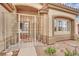 Inviting front entrance with decorative wrought iron security door and manicured artificial lawn at 4322 Summers Shade St, Las Vegas, NV 89147
