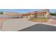 Beige single-story home featuring a spacious driveway, desert landscaping and a terracotta tile roof at 4322 Summers Shade St, Las Vegas, NV 89147