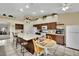 Open kitchen with a large island, wood cabinetry, breakfast nook, and easy access to the adjacent living areas at 4322 Summers Shade St, Las Vegas, NV 89147