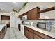 Spacious kitchen featuring dark wood cabinets, stainless appliances, and tile backsplash at 4322 Summers Shade St, Las Vegas, NV 89147