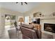 Inviting living room featuring a fireplace, comfortable recliner, and access to the backyard through sliding glass doors at 4322 Summers Shade St, Las Vegas, NV 89147