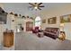 Spacious living room with neutral carpet, large windows, and decorative built-in shelving at 4322 Summers Shade St, Las Vegas, NV 89147