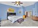 Comfortable bedroom with carpet, light-blue painted walls, and a ceiling fan at 4322 Summers Shade St, Las Vegas, NV 89147