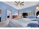 Comfortable bedroom with carpet, light-blue painted walls, and a view to the backyard at 4322 Summers Shade St, Las Vegas, NV 89147