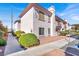 Exterior view of a well-maintained two-story building with landscaped surroundings and a clear blue sky at 4555 E Sahara Ave # 120, Las Vegas, NV 89104
