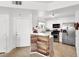 Well-maintained kitchen boasting modern appliances, white cabinets, and a breakfast bar at 4555 E Sahara Ave # 120, Las Vegas, NV 89104