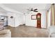Bright and open living room with neutral floors, a ceiling fan, grandfather clock and kitchen access at 4555 E Sahara Ave # 120, Las Vegas, NV 89104