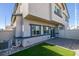 Modern home's backyard featuring a patio, synthetic grass, and well-maintained landscaping at 4790 Equinox Sky Ave # 2, North Las Vegas, NV 89084