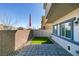 Private backyard featuring a small patch of turf and a stone patio at 4790 Equinox Sky Ave # 2, North Las Vegas, NV 89084