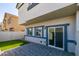 Backyard patio with sliding glass door and lawn area at 4790 Equinox Sky Ave # 2, North Las Vegas, NV 89084