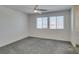 Carpeted bedroom with ceiling fan and two windows at 4790 Equinox Sky Ave # 2, North Las Vegas, NV 89084