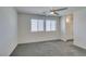Carpeted bedroom with two windows and ceiling fan at 4790 Equinox Sky Ave # 2, North Las Vegas, NV 89084