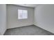 Carpeted bedroom with natural light from the window at 4790 Equinox Sky Ave # 2, North Las Vegas, NV 89084
