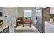 Cozy dining area with bench seating and stainless steel refrigerator at 4790 Equinox Sky Ave # 2, North Las Vegas, NV 89084