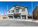 Modern townhome exterior features a balcony and three-car garages at 4790 Equinox Sky Ave # 2, North Las Vegas, NV 89084