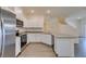 Well-lit kitchen features stainless appliances, white cabinets, and gray countertops at 4790 Equinox Sky Ave # 2, North Las Vegas, NV 89084