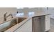 Close up on the island with stainless dishwasher and countertops at 4790 Equinox Sky Ave # 2, North Las Vegas, NV 89084