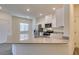 Bright kitchen features stainless appliances, white cabinets, and a large island with a sink at 4790 Equinox Sky Ave # 2, North Las Vegas, NV 89084