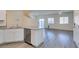 Open concept kitchen with stainless steel appliances, white cabinets, and an island at 4790 Equinox Sky Ave # 2, North Las Vegas, NV 89084