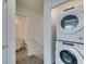 Convenient laundry area with a stacked washer and dryer next to a washroom at 4790 Equinox Sky Ave # 2, North Las Vegas, NV 89084