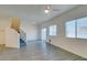 Bright living room with wood-look floors, a ceiling fan, and a sliding glass door for natural light at 4790 Equinox Sky Ave # 2, North Las Vegas, NV 89084
