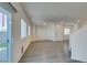 Spacious open-concept living area leads to kitchen and yard, with wood-look floors and bright natural light at 4790 Equinox Sky Ave # 2, North Las Vegas, NV 89084