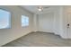 Inviting living area with wood-look floors, two windows, and a ceiling fan for added comfort at 4790 Equinox Sky Ave # 2, North Las Vegas, NV 89084