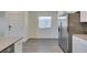 Open concept living and dining space with wood flooring and stainless steel refrigerator at 4790 Equinox Sky Ave # 2, North Las Vegas, NV 89084