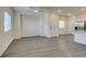 Open concept living room with wood-look flooring, a ceiling fan, and an adjacent kitchen area at 4790 Equinox Sky Ave # 2, North Las Vegas, NV 89084