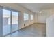 Open-concept living area boasts wood-look floors and an outdoor patio view through sliding glass doors at 4790 Equinox Sky Ave # 2, North Las Vegas, NV 89084