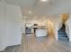 Bright living room and kitchen space with stairs leading to the upper level at 4790 Equinox Sky Ave # 2, North Las Vegas, NV 89084