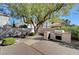 Well-maintained backyard with a built-in barbecue, mature tree, and serene landscaping for outdoor enjoyment at 4936 Mountain Foliage Dr, Las Vegas, NV 89148