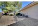 Home exterior backyard with mature trees and AC units at 4936 Mountain Foliage Dr, Las Vegas, NV 89148