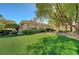 Beautifully landscaped backyard with artificial turf and mature trees at 4936 Mountain Foliage Dr, Las Vegas, NV 89148