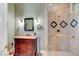 Bathroom with wooden vanity, custom lighting, and walk-in shower at 4936 Mountain Foliage Dr, Las Vegas, NV 89148