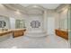 Elegant bathroom featuring marble floors, a luxurious tub, vanity and natural light at 4936 Mountain Foliage Dr, Las Vegas, NV 89148