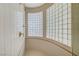 Luxurious shower stall with elegant gold fixtures and curved glass block window allowing natural light at 4936 Mountain Foliage Dr, Las Vegas, NV 89148