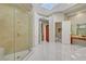 Spacious primary bathroom features marble floors, a glass shower, and vanity at 4936 Mountain Foliage Dr, Las Vegas, NV 89148