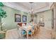The dining room boasts a decorative ceiling, chandelier, and a table set for eight, next to a china cabinet at 4936 Mountain Foliage Dr, Las Vegas, NV 89148