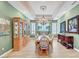 Formal dining room features a decorative chandelier, large china cabinet, and seating for eight at 4936 Mountain Foliage Dr, Las Vegas, NV 89148