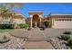 Elegant home featuring manicured landscaping, a tiled roof, and a circular driveway at 4936 Mountain Foliage Dr, Las Vegas, NV 89148