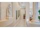 Elegant hallway with art display leading to living area with columns and plant life at 4936 Mountain Foliage Dr, Las Vegas, NV 89148