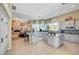 Open kitchen with granite countertops, two islands with seating, and access to the living area at 4936 Mountain Foliage Dr, Las Vegas, NV 89148